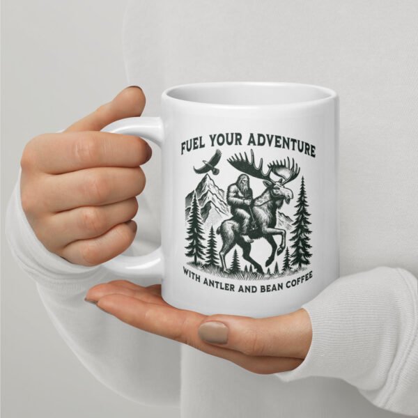 white-glossy-mug-white-20-oz-handle-on-left-68b8de13f3a5b.jpg Bigfoot, Eagle, Moose, Antler And Bean White glossy mug 20 oz